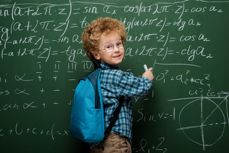 happy kid in glasses writing mathematical formulas 2021 09 03 16 45 58 utc11